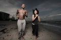 Man and woman running on the beach Royalty Free Stock Photo