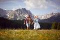 Man and woman running through a green field on a mountain.Smiling couple freedom on summer travel vacation Royalty Free Stock Photo