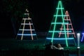 Man and Woman Sat on a Bench Enjoying Neon Light Display. Royalty Free Stock Photo