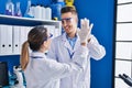 Man and woman scientists high five with hands raised up at laboratory Royalty Free Stock Photo