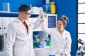 Man and woman scientists high five with hands raised up at laboratory Royalty Free Stock Photo