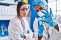 Man and woman scientists looking sample at street