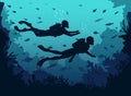 Man and woman scuba divers silhouette swimming in deep sea.