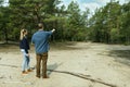 man and woman search a plot of land for country house construction