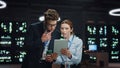 Man woman server technicians working pad computer in night data center closeup Royalty Free Stock Photo