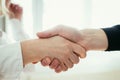 Shaking hands, concept for teamwork: Close up of man and woman shaking hands in the office Royalty Free Stock Photo