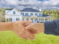 Man and Woman Shaking Hands in Front of New House Royalty Free Stock Photo