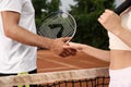 Man and woman shaking hands at tennis court Royalty Free Stock Photo