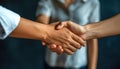 The man and woman are sharing an electric blue handshake gesture Royalty Free Stock Photo