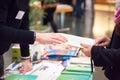 Man and Woman Sharing Information Leaflet over Exhibition Stand