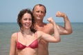 Man and woman show bicepses