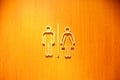 Man and woman sign symbols of toilet wooden door in a pub