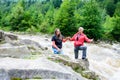 A man and a woman sing in the Carpathians on the background of the river