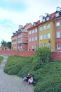 Man and woman sit on bench in city. Warsaw city architecture Royalty Free Stock Photo