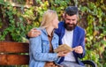 Man and woman sit bench park. Read same book together. Couple interested literature. Literature common interest. How to Royalty Free Stock Photo