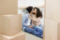 man, woman are sitting among cardboard boxes talking and kissing, mortgage or rental property. Royalty Free Stock Photo