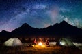 Man and woman sitting near tents in the evening