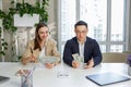 Man and woman sitting in office, holding money at hands. Gender pay gap, unequal salary concept Royalty Free Stock Photo