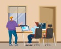 A man and a woman sitting at a table with laptop, communicating programmers develop new program code