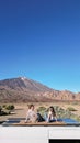 Man and Woman Sitting on Top of Van in Teide Volcano Mountain, Tenerife Royalty Free Stock Photo