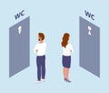 A man and a woman stand in front of the toilet doors