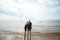 Man and woman standing on the beach and looking to the sea and blue sky Royalty Free Stock Photo