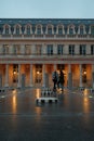 Man and woman standing in the courtyard of the Palais-Royal. Paris, France