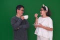 Man and woman standing and enjoying some snacks and evening tea Royalty Free Stock Photo