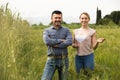 Man and woman standing in green field Royalty Free Stock Photo