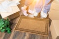 Man and Woman Standing Near Blank Welcome Mat, Moving Boxes Royalty Free Stock Photo