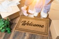 Man and Woman Standing Near Welcome Mat, Moving Boxes and Plant Royalty Free Stock Photo