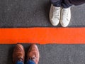 Close-up of people divided by a red line Royalty Free Stock Photo