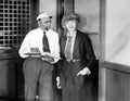 Man and woman standing together in a office doorway Royalty Free Stock Photo