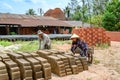 Man and woman staple handmade bricks near Mekong River, Vietnam Royalty Free Stock Photo