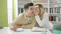 Man and woman students telling secret studying at library university Royalty Free Stock Photo