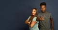 Man and woman studio portrait office workers team crossed arms pointing at camera on gray background Royalty Free Stock Photo