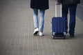 A man and a woman with a suitcase are on the sidewalk. Tourism and travel. Royalty Free Stock Photo