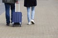 A man and a woman with a suitcase are on the sidewalk. Tourism and travel Royalty Free Stock Photo