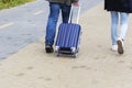 A man and a woman with a suitcase are on the sidewalk. Tourism and travel. Royalty Free Stock Photo