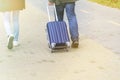 A man and a woman with a suitcase are on the sidewalk. Tourism and travel Royalty Free Stock Photo