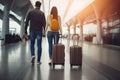 A young loving couple of tourists waiting for a plane flight. Man and woman with suitcases at the airport. Concept: travel, Royalty Free Stock Photo