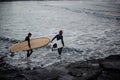 Man and woman with surfboards going to water Royalty Free Stock Photo