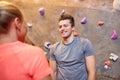 Man and woman talking at indoor climbing gym wall Royalty Free Stock Photo