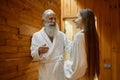 Man and woman talking in spa sauna