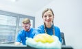 Man and woman team of commercial cleaners working