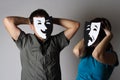 Man and woman in theatre emotions masks