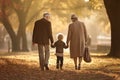 A man, a woman, and their child walking together in a park, enjoying a beautiful day outdoors, Senior couple and grandchild