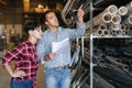 Man and woman together carry out accounting and inventory in a building materials warehouse Royalty Free Stock Photo