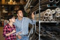 Man and woman together carry out accounting and inventory in a building materials warehouse Royalty Free Stock Photo