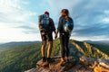 A man and a woman in tourist equipment are standing on a rock and admiring the panoramic view. Royalty Free Stock Photo